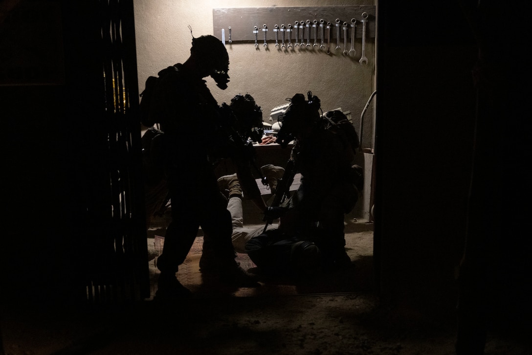 U.S. Marines with Battalion Landing Team 1/8, conduct a joint raid with critical skills operators from Marine Forces Special Operations Command during an integration training event on Camp Lejeune, North Carolina, Nov. 21, 2023. MARSOC worked with Marines from BLT 1/8 to increase interoperability with the Fleet Marine Force. (U.S. Marine Corps photo by Cpl. Henry Rodriguez)