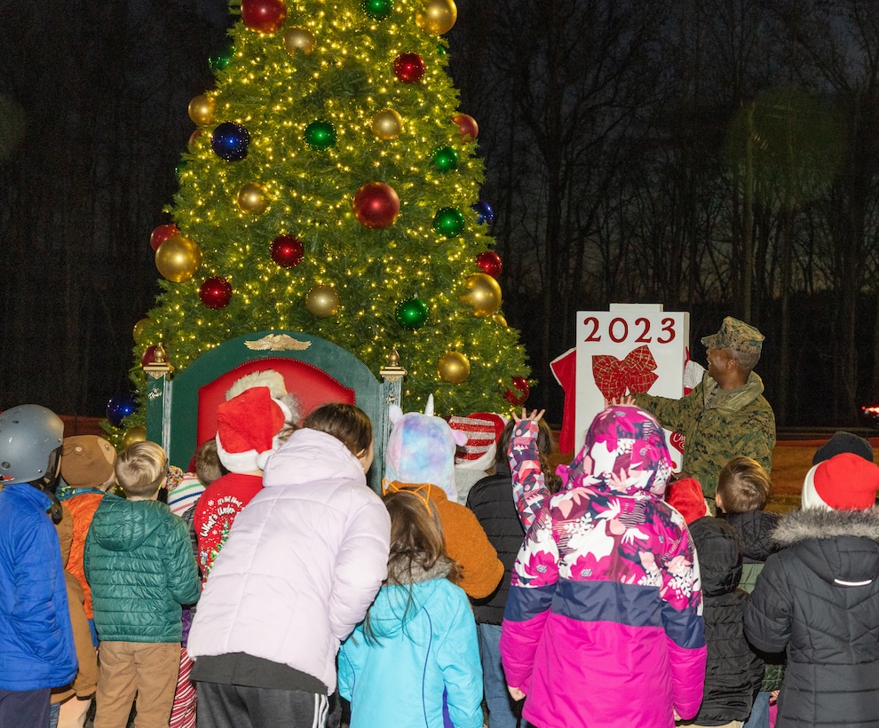 U.S. Marine Corps Col. Michael L. Brooks, base commander, Marine Corps Base Quantico, lights up the base holiday tree during the annual Quantico holiday tree lighting at the Marine Corps Exchange parking lot on Marine Corps Base Quantico, Virginia, Dec. 7, 2023. The festivities included a roller-skating rink, snowball fighting, games for children, music performances, and vendor booths all to celebrate the holiday season. (U.S. Marine Corps Photo by Lance Cpl. Kayla LeClaire)
