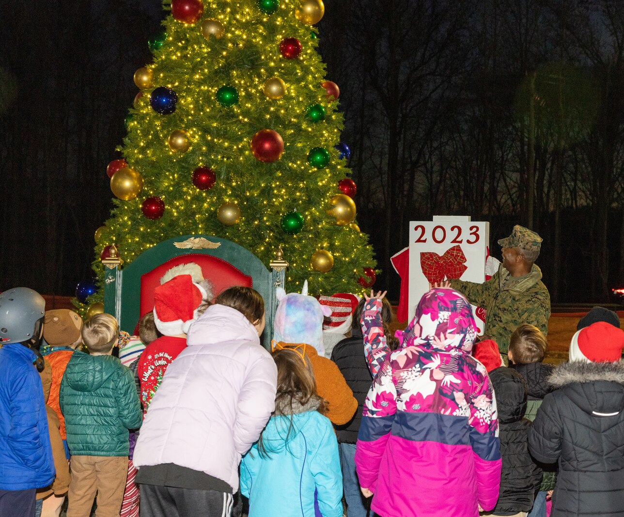 U.S. Marine Corps Col. Michael L. Brooks, base commander, Marine Corps Base Quantico, lights up the base holiday tree during the annual Quantico holiday tree lighting at the Marine Corps Exchange parking lot on Marine Corps Base Quantico, Virginia, Dec. 7, 2023. The festivities included a roller-skating rink, snowball fighting, games for children, music performances, and vendor booths all to celebrate the holiday season. (U.S. Marine Corps Photo by Lance Cpl. Kayla LeClaire)