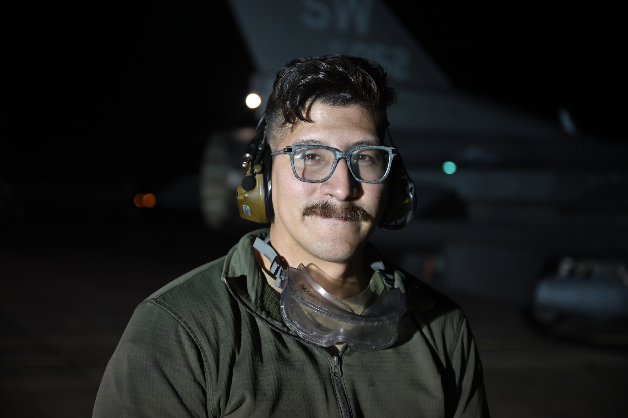 maintainer smiles at camera at night