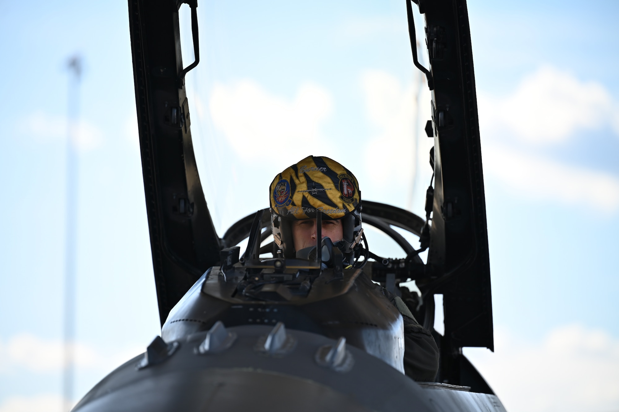 pilot sits in cockpit of a jet