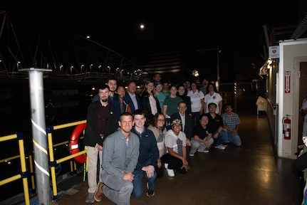 RIT and NTID students pose alongside Carderock employees at the Maneuvering and Seakeeping Basin