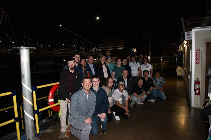 RIT and NTID students pose alongside Carderock employees at the Maneuvering and Seakeeping Basin