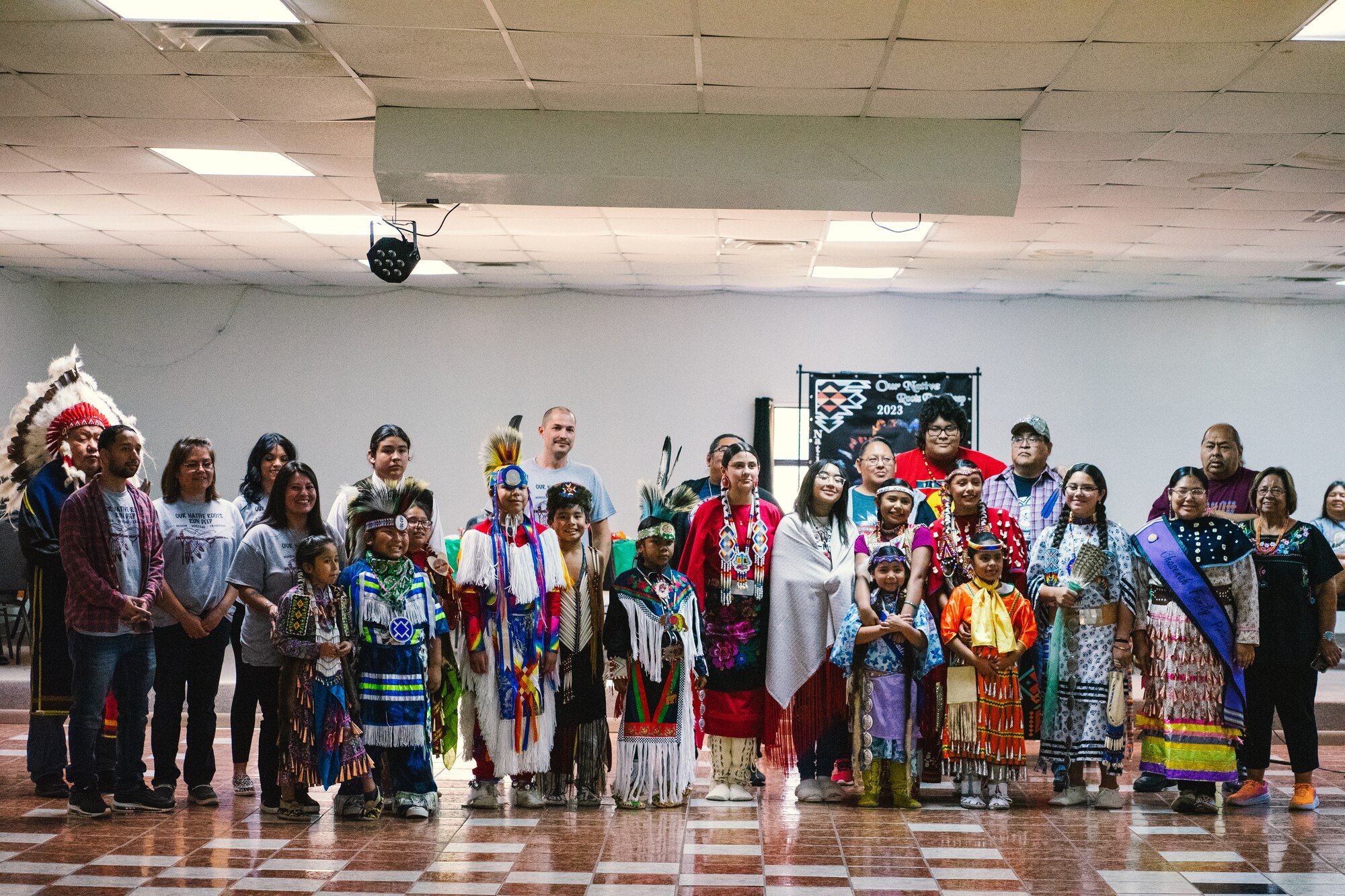 Native American members of the community pose for a photo during an intertribal event in Lonewolf, Oklahoma, Nov. 18, 2023. The event featured art, beading, music, and dancing in celebration of Native American Indian Heritage Month. (U.S. Air Force photo by Airman 1st Class Shae Herrera)
