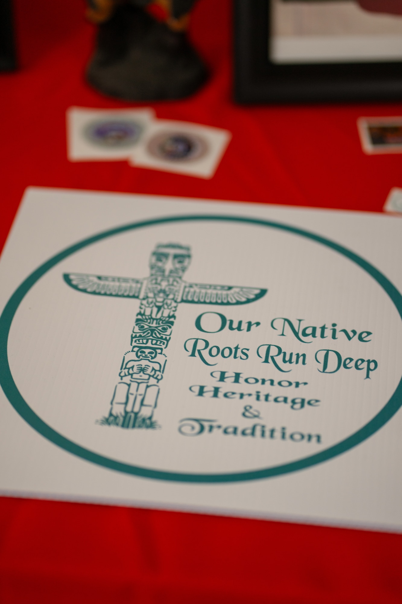 An “Our Native Roots Run Deep” coaster is placed on a table during an intertribal community event in Lonewolf, Oklahoma, Nov. 18, 2023. The event featured art, beading, music, and dancing in celebration of Native American Indian Heritage Month. (Courtesy photo by Airman 1st Class Shae Herrera)