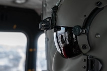 Senior Airmen Erin Ebenstein, flight engineer 54th Helicopter Squadron, looks on inside of a UH-1N Iroquois at Minot Air Force Base, North Dakota on December 10, 2023. This was part of a yearly event where Santa Claus and his elf helper fly over Minot Air Force Base and Minot, N.D. to greet the children of Team Minot. (U.S. Air Force photo by A1C Luis Gomez)