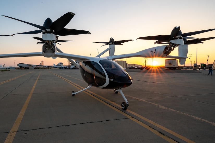 An electric aircraft is photographed on a runway.