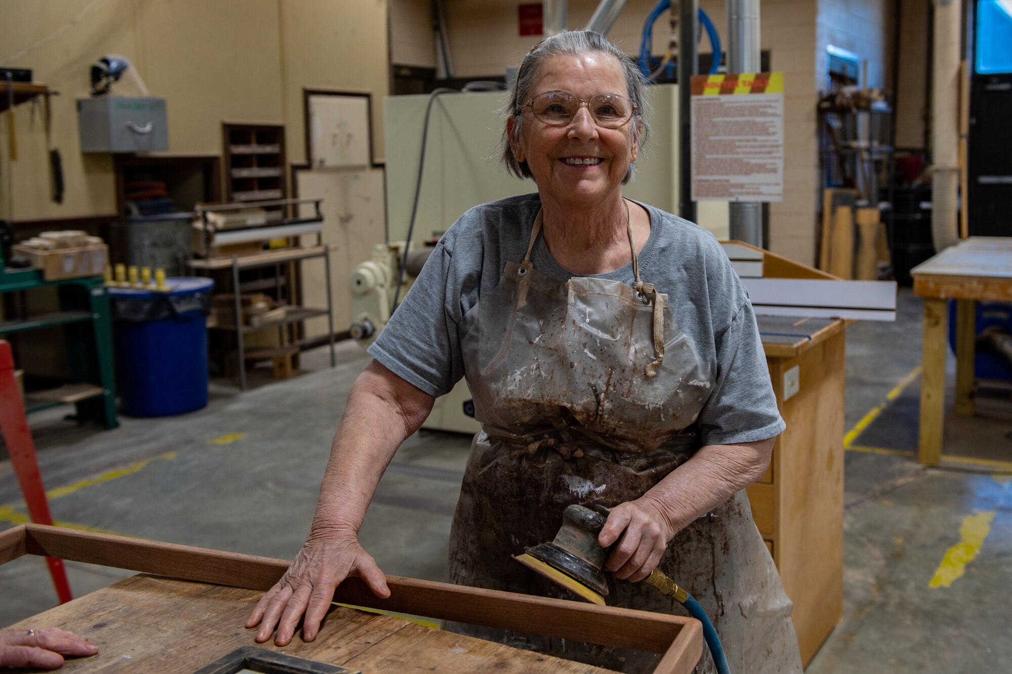 Gail Fischbach, 23rd Force Support Squadron recreation woodshop volunteer, smiles in the woodshop at Moody Air Force Base, Georgia, Nov. 28, 2023. Fischbach has volunteered for over 11 years at the woodshop at Moody. (U.S. Air Force photo by Senior Airman Courtney Sebastianelli)