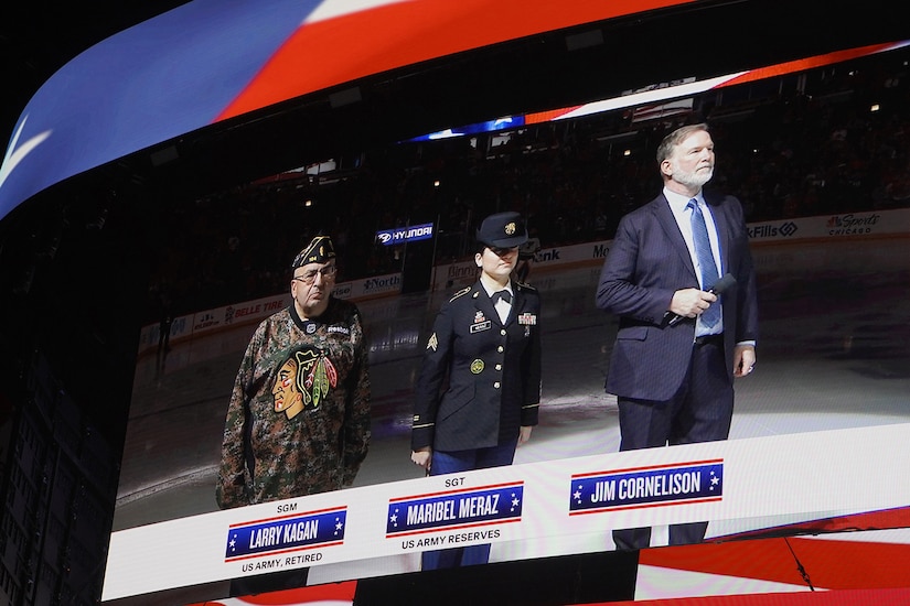 U.S. Army Reserve Sgt. Maribel Meraz, center, 85th U.S. Army Reserve Support Command, receives an honor for her service before the playing of the National Anthem at the Chicago Blackhawks home game versus St. Louis Blues, December 9, 2023.