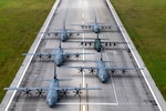 Three U.S. Air Force (USAF) C-130J Super Hercules aircraft assigned to the 36th Expeditionary Airlift Squadron participate in an elephant walk alongside a Royal Canadian Air Force (RCAF) C-130J Super Hercules assigned to the 436th Transport Squadron, a Japan Air Self-Defense Force (JASDF) C-130H Hercules assigned to the 401st Tactical Airlift Squadron, and a Republic of Korea Air Force (ROKAF) C-130H Hercules assigned to the 251st Airlift Squadron, at Andersen Air Force Base, Guam, Dec. 9, 2023, during Operation Christmas Drop 2023 (OCD 23). USAF, RCAF, JASDF, and ROKAF crewmembers delivered 210 bundles to 58 islands over the span of six days. The deliveries of humanitarian aid reached over 42 thousand remote Micronesian islanders across 1.8 million square miles. (U.S. Air Force photo by Tech. Sgt. Taylor Altier)