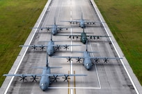 Three U.S. Air Force (USAF) C-130J Super Hercules aircraft assigned to the 36th Expeditionary Airlift Squadron participate in an elephant walk alongside a Royal Canadian Air Force (RCAF) C-130J Super Hercules assigned to the 436th Transport Squadron, a Japan Air Self-Defense Force (JASDF) C-130H Hercules assigned to the 401st Tactical Airlift Squadron, and a Republic of Korea Air Force (ROKAF) C-130H Hercules assigned to the 251st Airlift Squadron, at Andersen Air Force Base, Guam, Dec. 9, 2023, during Operation Christmas Drop 2023 (OCD 23). USAF, RCAF, JASDF, and ROKAF crewmembers delivered 210 bundles to 58 islands over the span of six days. The deliveries of humanitarian aid reached over 42 thousand remote Micronesian islanders across 1.8 million square miles. (U.S. Air Force photo by Tech. Sgt. Taylor Altier)