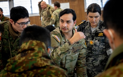 Japanese, U.S., and Australian participants take part in a rehearsal during Yama Sakura 85 at Camp Higashi-Chitose, Japan, Dec. 11, 2023. Members from the three nations worked together each day and shared a combined command post. As a part of U.S. Army Pacific's Operation Pathways, the 43rd iteration of Yama Sakura exercise, YS-85, is the first U.S. Army, Japan Ground Self-Defense Force, and Australian Army command post exercise based in Japan. (U.S. Army photo by Spc. Austin Robertson)