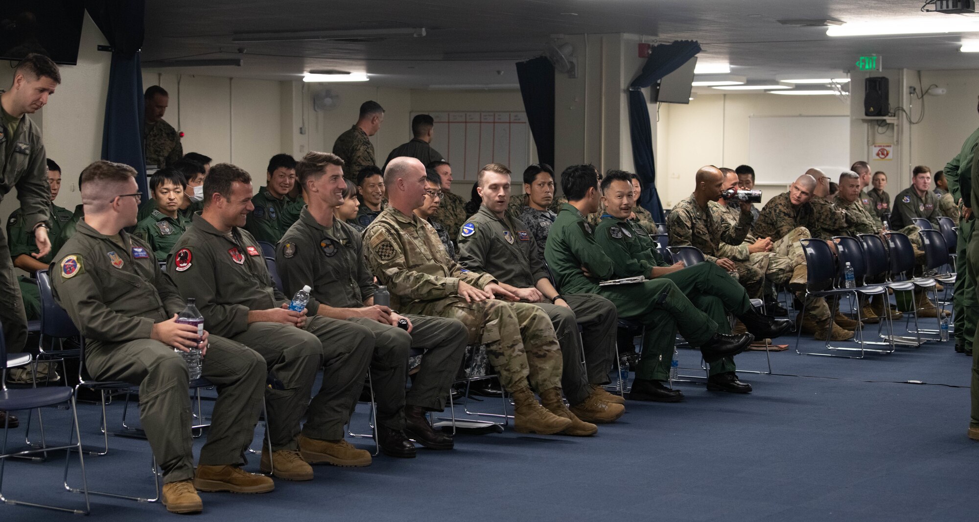 Japan Aerial Self-Defense Force, U.S. Air Force and U.S. Marine Corps Service members wait before the start of the Okinawa Bilateral Tactics Exchange