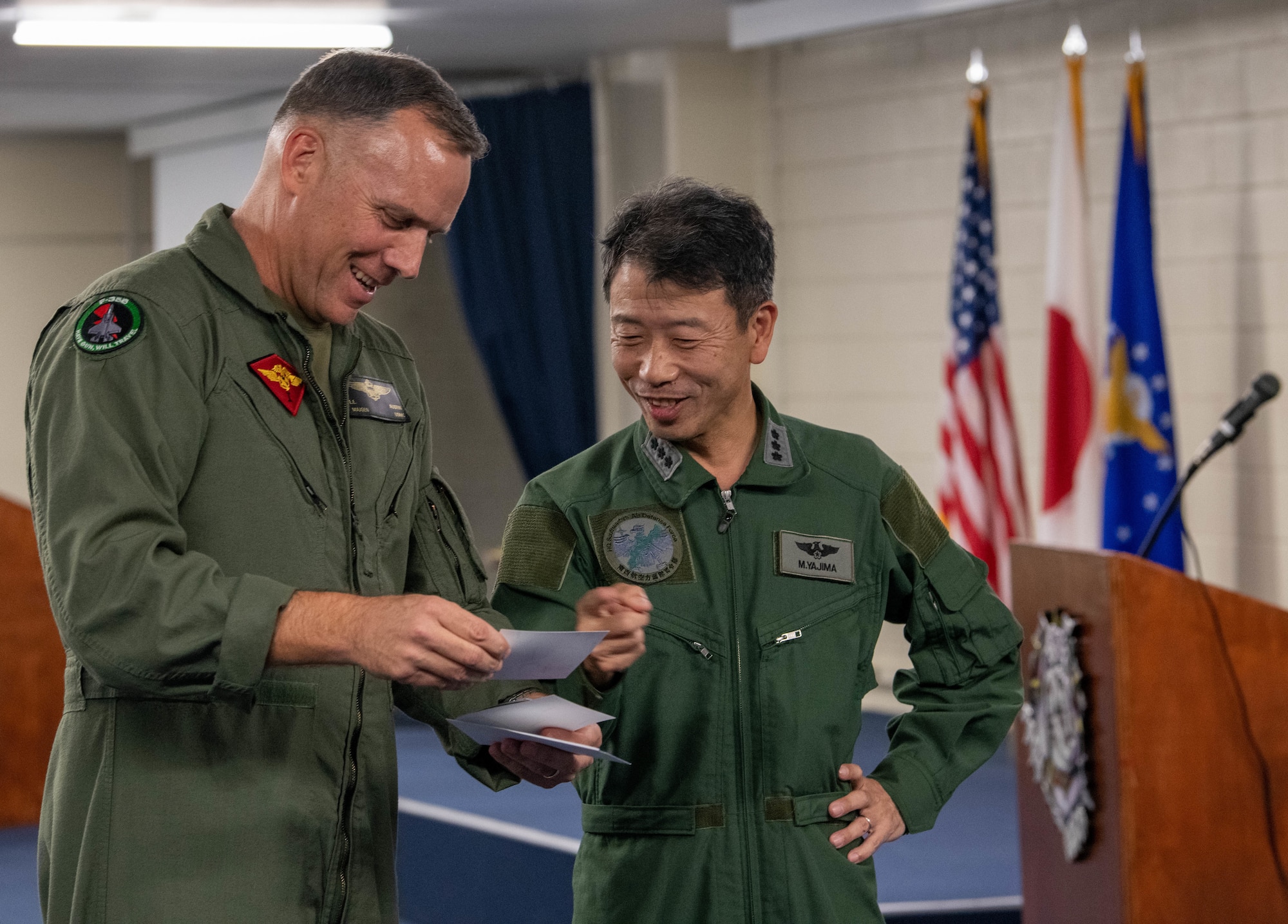 Japan Air Self-Defense Force Lt. Gen. Masahito Yajima and U.S. Marine Corps Maj. Gen. Eric Austin converse together.