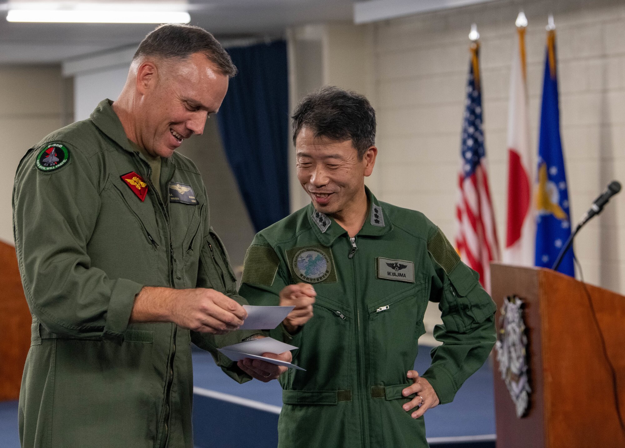 Japan Air Self-Defense Force Lt. Gen. Masahito Yajima and U.S. Marine Corps Maj. Gen. Eric Austin converse together.