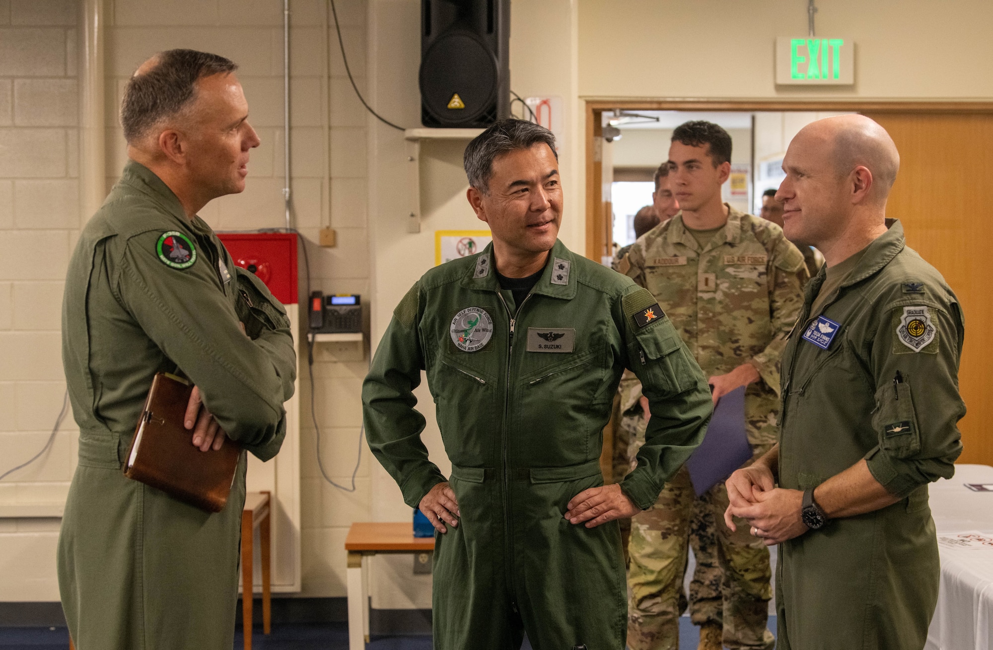 U.S. Marine Corps Maj. Gen. Eric Austin and U.S. Air Force Col. Nicholas Evans converse with Japan Air Self-Defense Force Maj. Gen. Shigenao Suzuki.