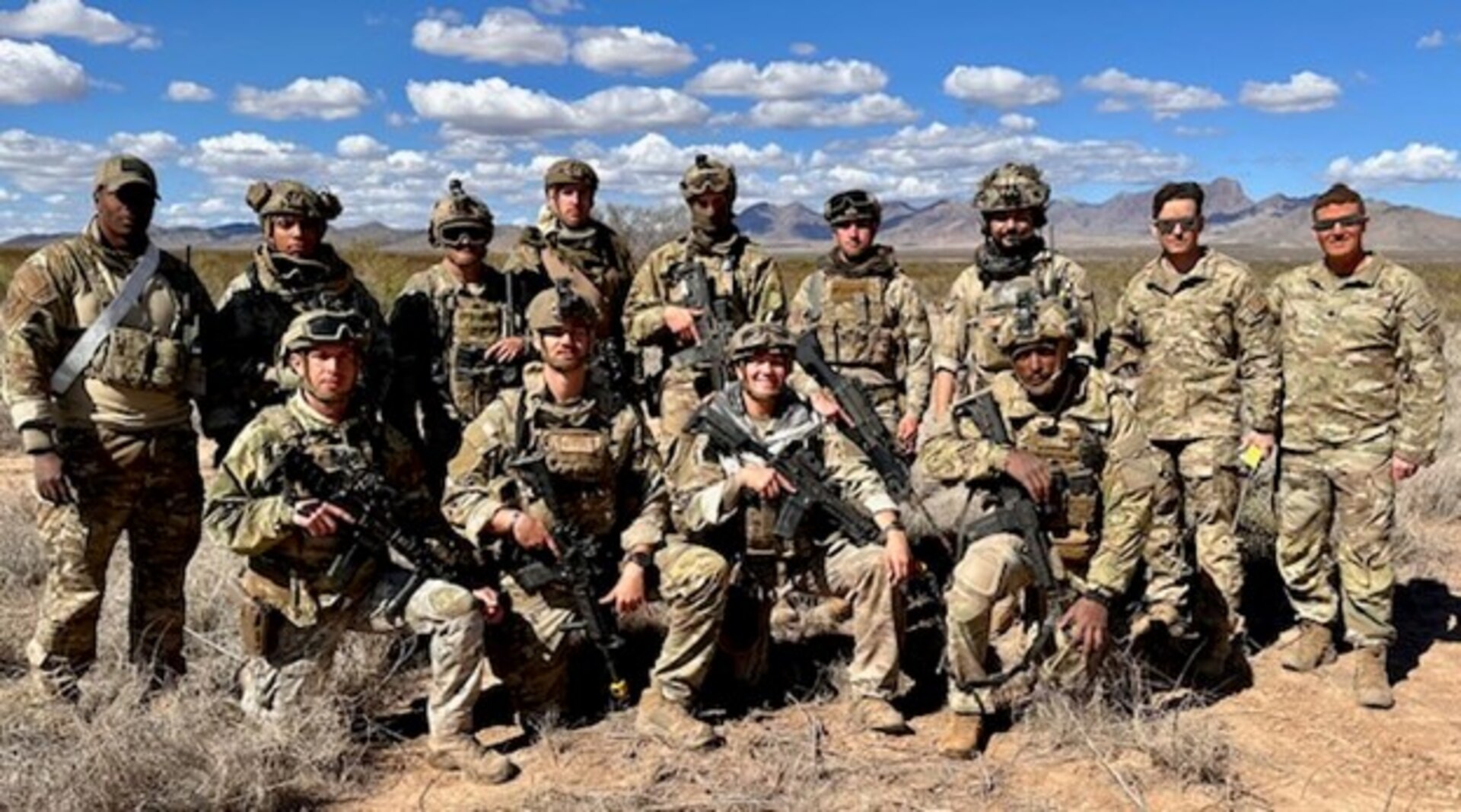 Group photo of 13 Air Force Security Forces Members in the desert on a Fort Bliss, Texas, training range.