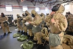 U.S. Air Force Capt. Brandon McGraw, 173rd Maintenance Operations Flight commander, dons full “chem gear” during chemical, biological, radiological, nuclear and explosives training, Dec. 3, 2023, at Kingsley Field in Klamath Falls, Oregon.