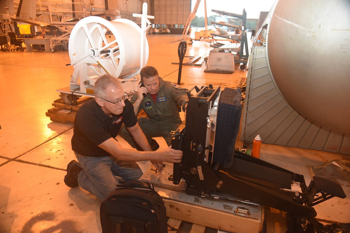 Bob Gansman, director of technology development for Safe, Inc., and VX-20 E-2 Project Officer and NFO Lt. Nicholas “Reek” Jahrmarkt install the “feet” on MAVRIC.