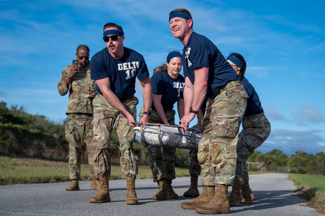 Space Force personnel carry a litter.