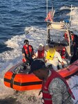 The Coast Guard Cutter Pablo Valent crew repatriates 20 migrants to a Dominican Republic Navy vessel just off San Pedro de Macoris, Dominican Republic, Dec. 8, 2023.  The Coast Guard Cutter Richard Dixon interdicted the migrant group aboard a grossly overloaded makeshift vessel taking part in unlawful irregular migration voyage in the Mona Passage, Dec. 7, 2023. (Courtesy photo)