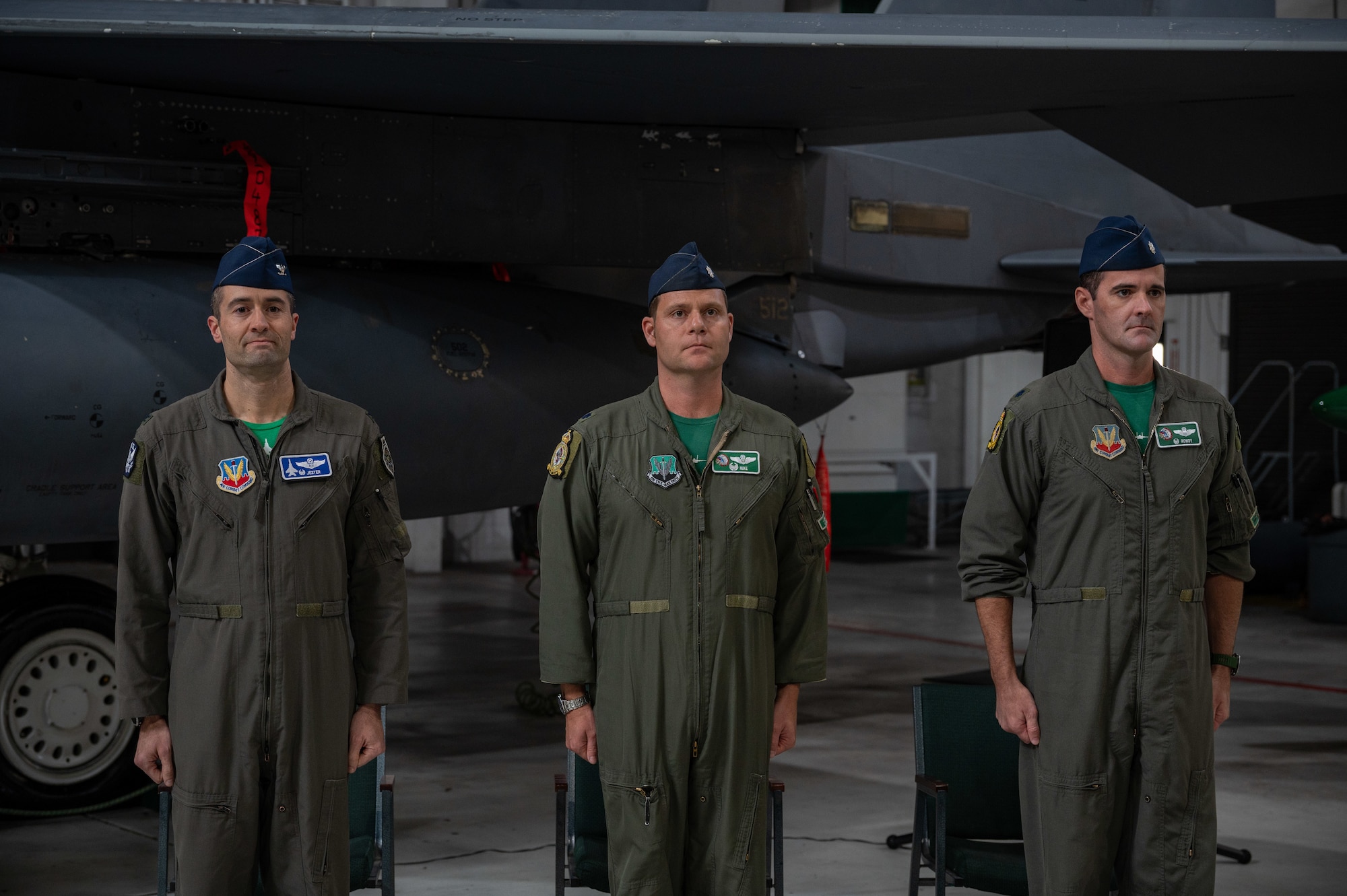 U.S. Air Force Col. Morgan P. Lohse, 4th Operations Group Commander, left, Lt. Col. John D. Rabun, former 335th Fighter Squadron Commander, middle, and Lt. Col. Kevin W. Murphy, 335th FS Commander, right, stand at attention during a change of command ceremony at Seymour Johnson Air Force Base, North Carolina, Dec. 8, 2023. The ceremony was conducted to commemorate the passing of command of the squadron from Rabun to Murphy. (U.S. Air Force photo by Airman 1st Class Leighton Lucero)