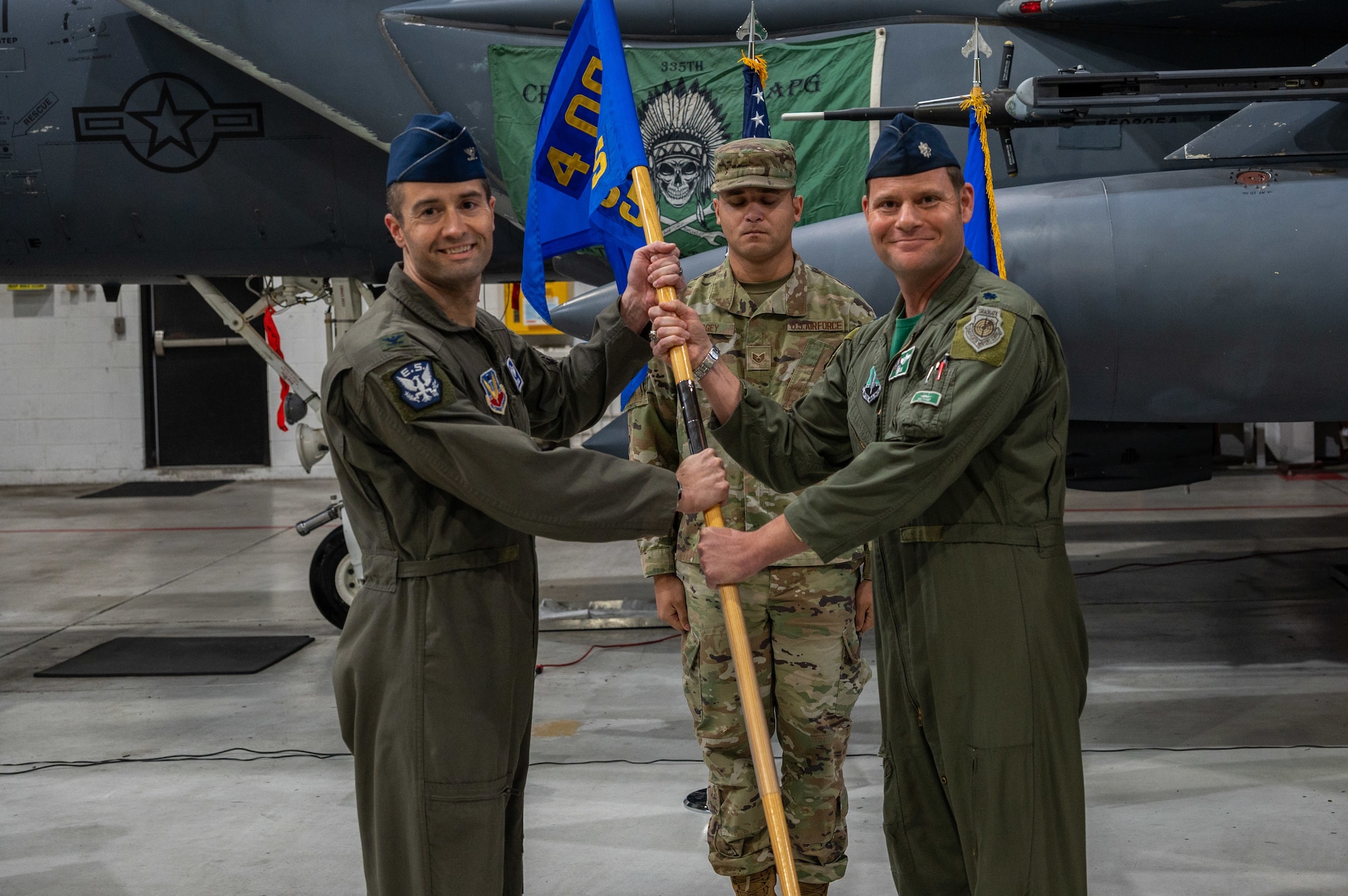U.S. Air Force Col. Morgan P. Lohse, left, 4th Operations Group Commander, receives the guidon from Lt. Col. John D. Rabun, former 335th Fighter Squadron Commander during the squadrons change of command ceremony at Seymour Johnson Air Force Base, North Carolina, Dec. 8, 2023. Under Rabuns command, the 335th FS earned the Raytheon Award during fiscal year 2022. (U.S. Air Force photo by Airman 1st Class Leighton Lucero)