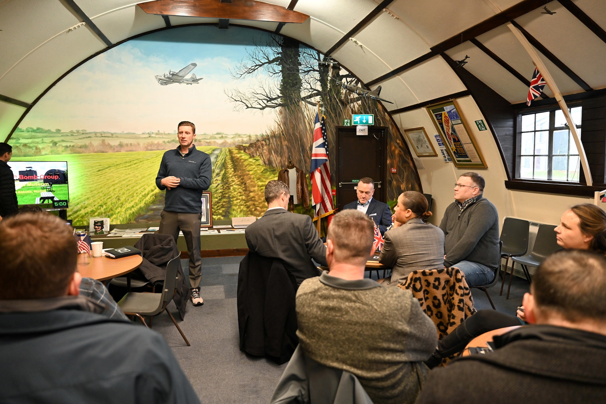 U.S. Air Force Col. Ryan Garlow, 100th Air Refueling Wing commander, discusses strategic initiatives with commanders and senior leaders at the 100th Bomb Group Memorial Museum, Thorpe Abbotts, Norfolk, England, Dec. 4, 2023. Base leadership from Royal Air Force Mildenhall spent time at the museum for an off-site meeting, followed by a tour to learn more about the heritage of the 100th ARW. (U.S. Air Force photo by Karen Abeyasekere)