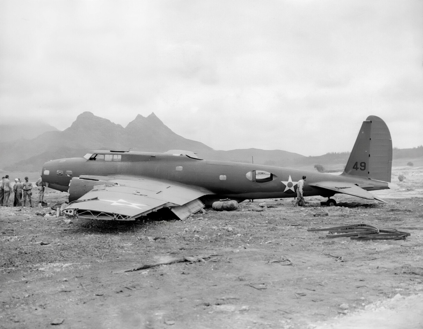 Ground crewmen cannibalize B-17C, serial number 40-2049, which landed at Bellows Field piloted by 1st Lt. Robert Richards, for other B-17s at Hickam. The Plexiglas nose canopy has already been taken as has the port wing tip, two engines, an aileron and the observation bubble behind the cockpit. The B-17C and later D were the last models before a twin .50 caliber machine gun tail station was added to the next variant B-17E to greatly improve the bomber’s defense armament.