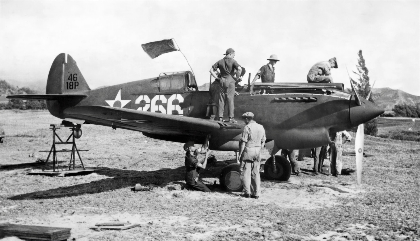 This early P-40 is from the 18th Pursuit Group, and the ground crew is bore-sighting its twin nose-mounted .50-caliber machine guns at Bellows Field sometime in the summer or fall of 1941. This procedure ensures the guns’ bullets converge at a desired range.