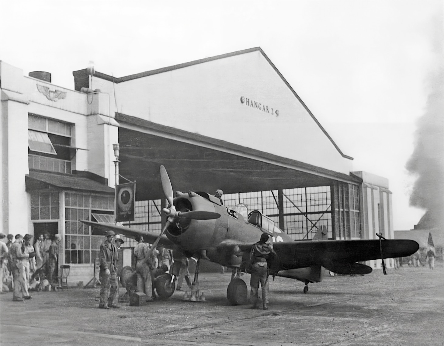 This P-36A is in front of Hangar 2 and may have been flown by 1st Lt. Lewis M. Sanders, CO of the 46th Pursuit Squadron on the morning of Dec. 7. It appears that the workers have raised the covers of the breeches of the nose .50-caliber machine guns. Sanders received the Silver Star for leading four P-36s against a formation of Japanese Zero fighters, with a furious dogfight developing.