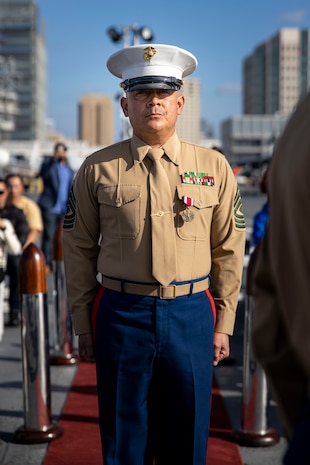 U.S. Marine Corps 1st Sgt. Christian Fuentes, Company First Sergeant with Third Recruit Training Battalion, Marine Corps Recruit Depot San Diego stands at attention during his retirement ceremony aboard the USS Midway (CV-41) Museum, San Diego, Dec. 7, 2023. Fuentes retired after 21 years of faithful service and held his retirement ceremony on the remembrance day of Pearl Harbor, to commemorate and honor the fallen service members. (U.S. Marine Corps photo by Sgt. Yvonna Guyette)