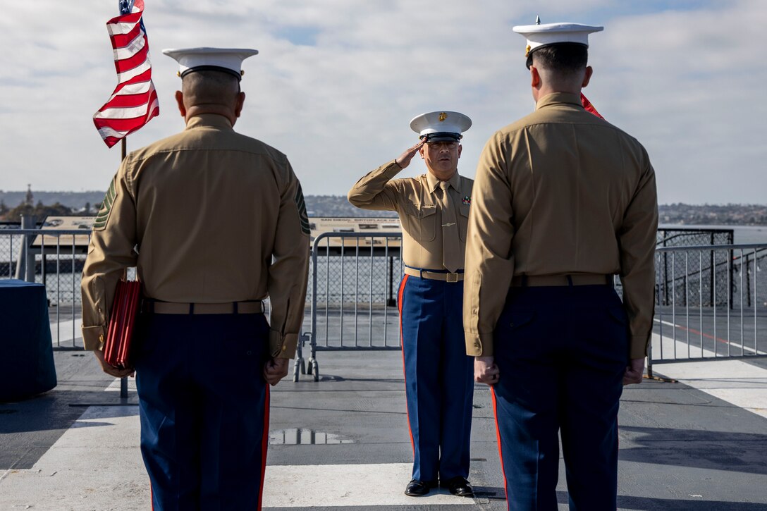 U.S. Marine Corps 1st Sgt. Christian Fuentes, Company First Sergeant with Third Recruit Training Battalion, Marine Corps Recruit Depot San Diego salutes during his retirement ceremony aboard the USS Midway (CV-41) Museum, San Diego, Dec. 7, 2023. Fuentes retired after 21 years of faithful service and held his retirement ceremony on the remembrance day of Pearl Harbor, to commemorate and honor the fallen service members. (U.S. Marine Corps photo by Sgt. Yvonna Guyette)
