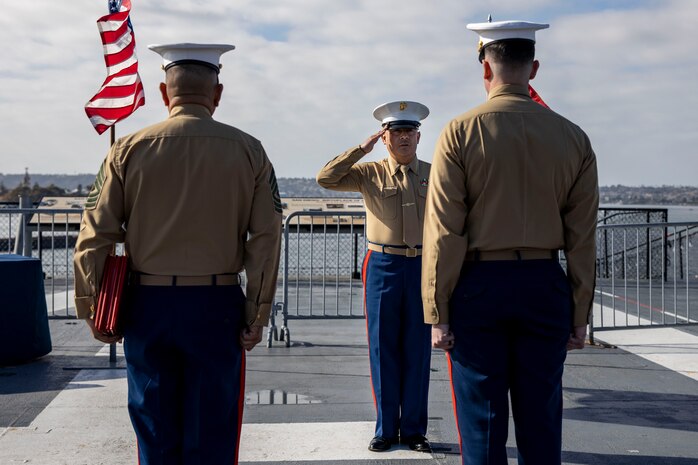 U.S. Marine Corps 1st Sgt. Christian Fuentes, Company First Sergeant with Third Recruit Training Battalion, Marine Corps Recruit Depot San Diego salutes during his retirement ceremony aboard the USS Midway (CV-41) Museum, San Diego, Dec. 7, 2023. Fuentes retired after 21 years of faithful service and held his retirement ceremony on the remembrance day of Pearl Harbor, to commemorate and honor the fallen service members. (U.S. Marine Corps photo by Sgt. Yvonna Guyette)