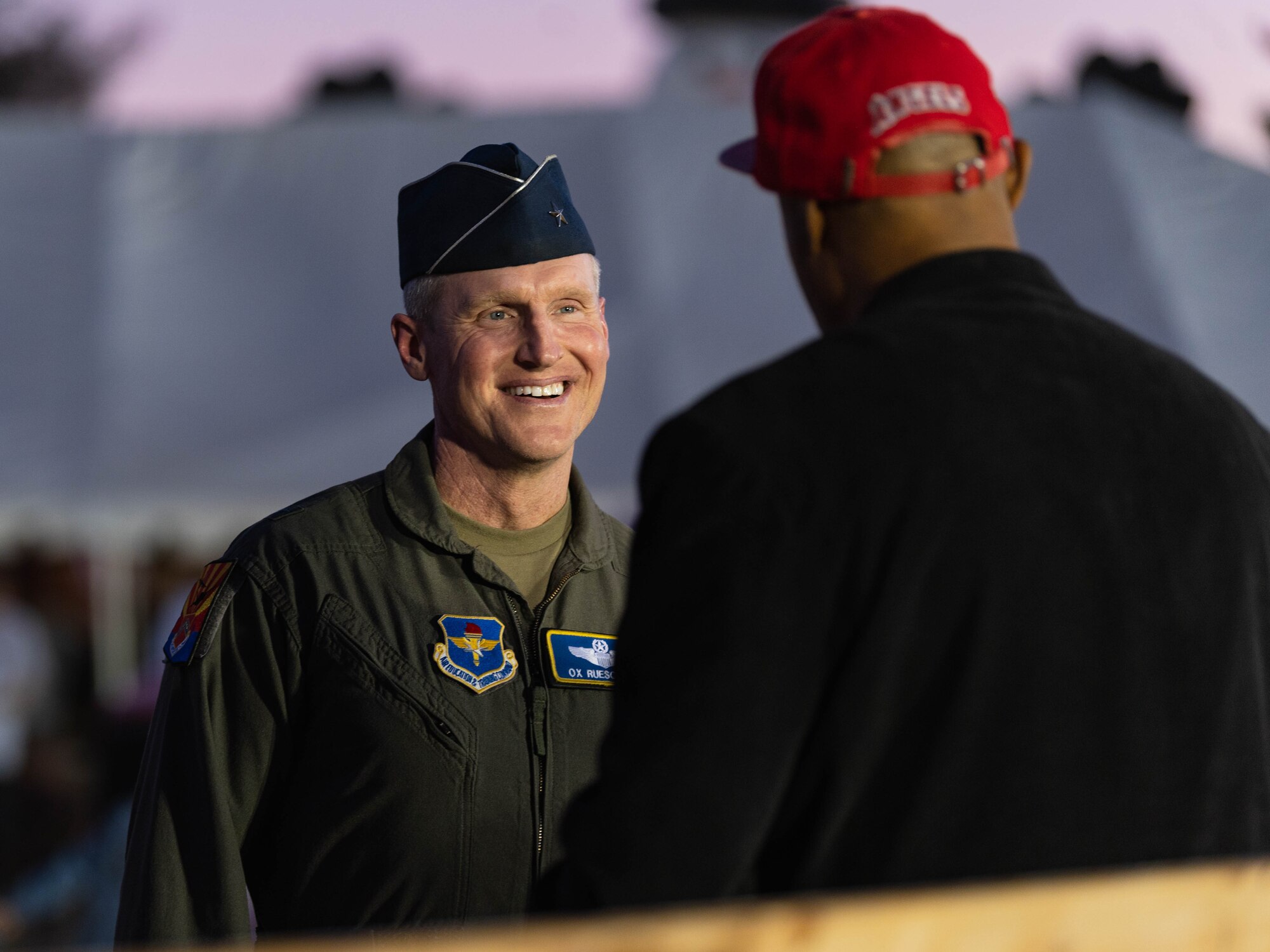 U.S. Air Force Brig. Gen. Jason Rueschhoff (right), 56th Fighter Wing commander, and Chief Master Sgt. Jason Shaffer (left), 56th Fighter Wing command chief, address Luke Air Force Base personnel and their families during a Holiday Magic event.