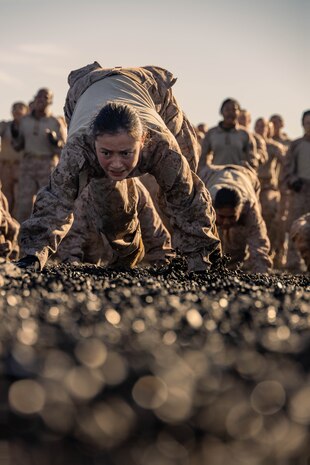 U.S. Marine Corps Recruit Nadelynn Maes, with Echo Company, 2nd Recruit Training Battalion, participates in dynamic warm-ups before a Marine Corps Martial Arts Program training event at Marine Corps Recruit Depot San Diego, Nov. 27, 2023. MCMAP aims to strengthen the mental and moral resiliency of recruits and Marines through realistic combative training, warrior ethos studies, and physical hardening. Maes is a native of Taos, New Mexico. (U.S. Marine Corps photo by Lance Cpl. Janell B. Alvarez)