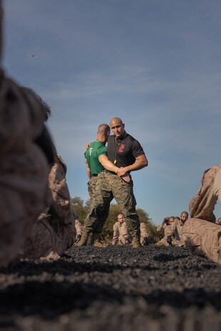 U.S. Marine Corps Staff Sgt. Javier Acosta, a martial arts instructor with Support Battalion, demonstrates a technique to Echo Company, 2nd Recruit Training Battalion, during a Marine Corps Martial Arts Program training event at Marine Corps Recruit Depot San Diego, Nov. 27, 2023. MCMAP aims to strengthen the mental and moral resiliency of recruits and Marines through realistic combative training, warrior ethos studies, and physical hardening. Acosta is a native of Phoenix, Arizona. (U.S. Marine Corps photo by Lance Cpl. Janell B. Alvarez)