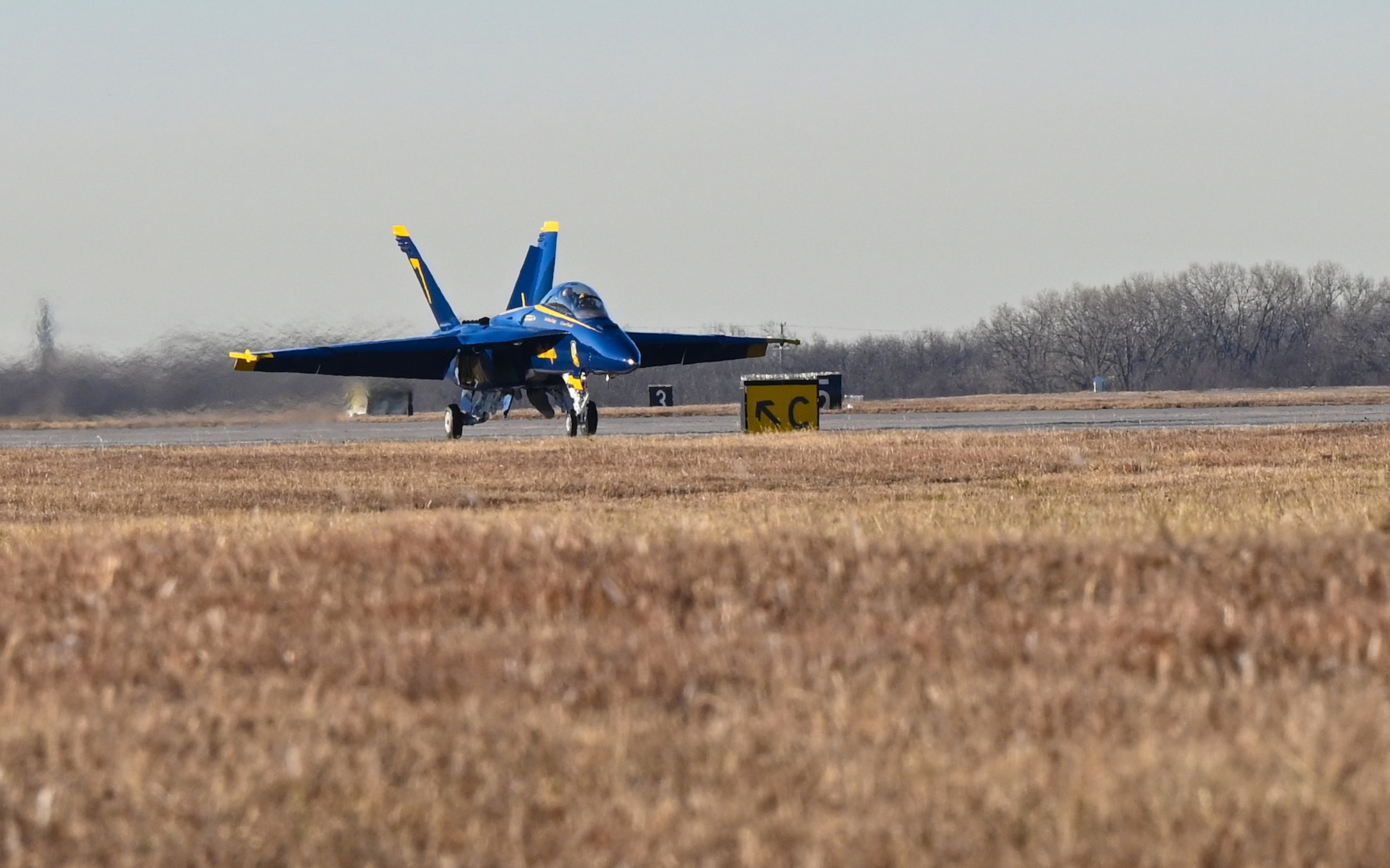 Members of the U.S. Navy Flight Demonstration Squadron, the Blue Angels, taxi to their parking spot Dec. 11, 2023, at McConnell Air Force Base, Kansas. Two Blue Angels visited McConnell in preparation for their part in the Frontiers in Flight Air Show on Aug. 24-25, 2024. (U.S. Air Force photo by Staff Sgt. Tryphena Mayhugh)
