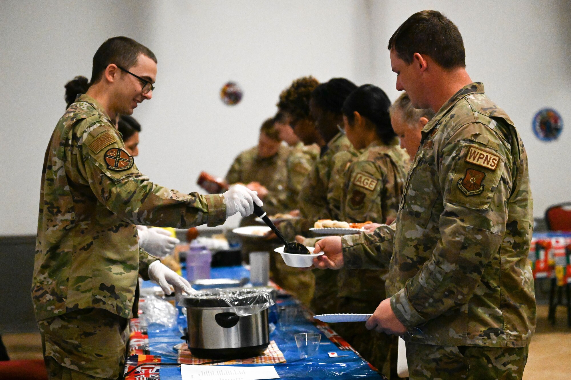 Service members served cuisines from various cultures during Barksdale Air Force Base’s inaugural “Around-the-World” potluck. (U.S. Air Force photo by Senior Airman Danielle James)