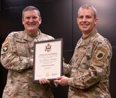 Col. Lenny Williams, Illinois Army National Guard Chief of Staff, presents Chief Warrant Officer 2 Peter E. Warren, Jr., with a certificate of retirement during a ceremony Dec. 8 at Camp Lincoln, Springfield, Illinois. Warren retired after 24 years of service in the Illinois National Guard.
