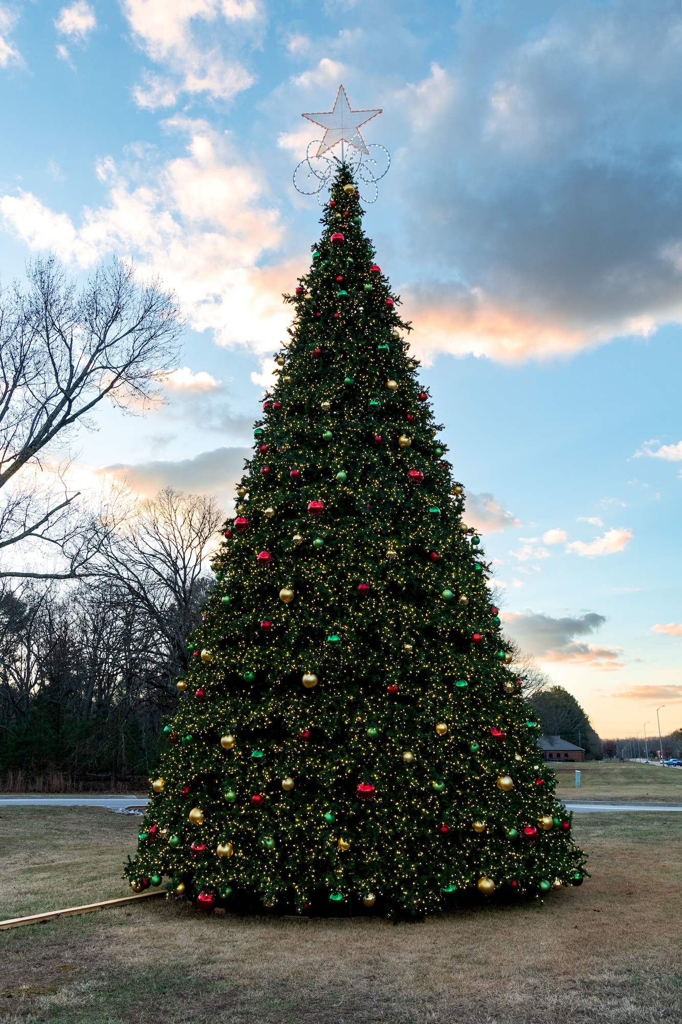 The Christmas tree at Arnold Air Force Base, Tenn., is lit during a lighting ceremony Dec. 4, 2023. The tree measures 40 feet tall and 22 feet wide. It is decorated with approximately 300 ball ornaments and is topped with a 5-foot 3D five-point star. (U.S. Air Force photo by Keith Thornburgh)