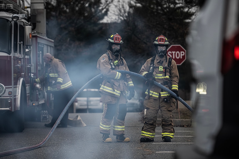 Firefighters from the 87th Civil Engineer Squadron respond to a vehicle emitting smoke during Jersey Dawn 23 on Joint Base McGuire-Dix-Lakehurst, N.J., Dec. 7, 2023. Members assigned to several units across the joint base participated in the exercise, a six-day joint training event from Dec. 4-9, 2023. (U.S. Air Force photo by Staff Sgt. Austin Knox)
