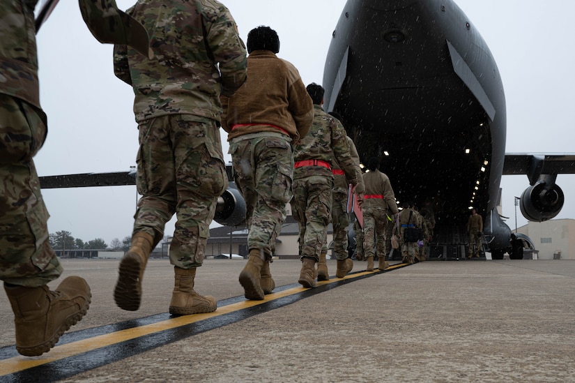 Members from the 87th Air Base Wing board a C-17 Globemaster III during Jersey Dawn 23 on Joint Base McGuire-Dix-Lakehurst, N.J., Dec. 7, 2023. Members assigned to several units across the joint base participated in the exercise, a six-day joint training event from Dec. 4-9, 2023. (U.S. Air Force photo by Airman 1st Class Aidan Thompson)