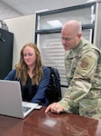 (L) Megan Hart Lee, USMEPCOM's first clinical psychologist, receives training from Air Force Capt. Daniel Strickland, USMEPCOM deputy command surgeon, during her initial onboarding. The new team of clinical psychologists at USMEPCOM will conduct applicant behavioral health consults in an effort to reduce timelines for entry to service.