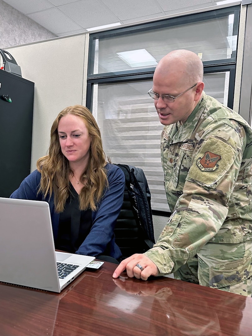 (L) Megan Hart Lee, USMEPCOM's first clinical psychologist, receives training from Air Force Capt. Daniel Strickland, USMEPCOM deputy command surgeon, during her initial onboarding. The new team of clinical psychologists at USMEPCOM will conduct applicant behavioral health consults in an effort to reduce timelines for entry to service.