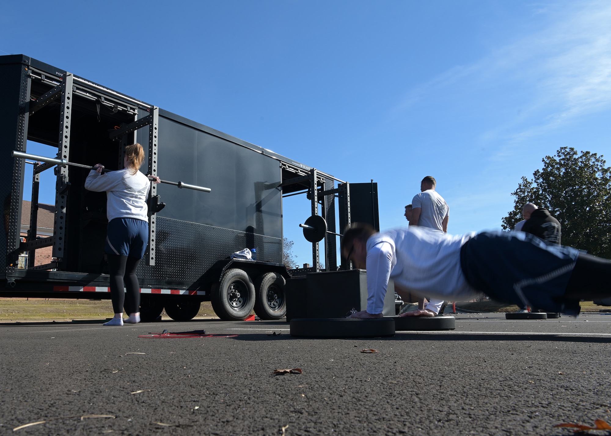 Airmen perform fitness exercises.