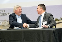 IMAGE: Fredericksburg Military Affairs Council Chairman Dr. John Burrow (left) shakes hands with Naval Surface Warfare Center Dahlgren Division Technical Director Dale Sisson Jr., P.E., SES, after the pair signed a Memorandum of Agreement at the end of the Potomac Tech Bridge kickoff event Dec. 12 at University of Mary Washington Dahlgren Campus.