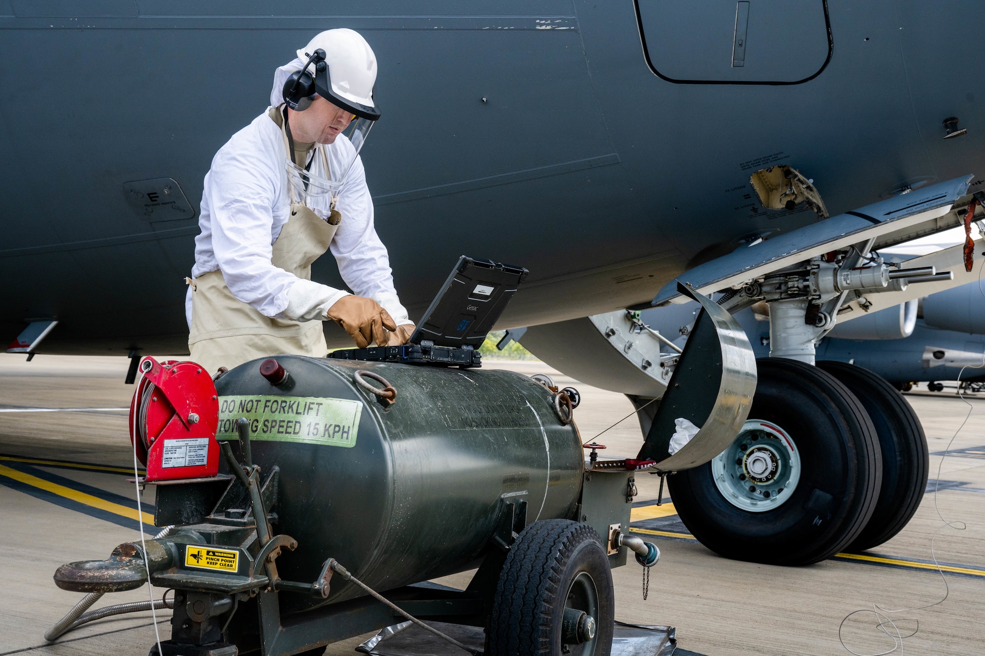 U.S. Air Force Tech. Sgt. Carl Haynes, 15th Aircraft Maintenance Squadron electrical and environmental technician, prepares to replenish liquid oxygen in a C-17 Globemaster III during Exercise Global Dexterity 2302 at Royal Australian Air Force Amberley, Nov. 29. 2032.  Exercise Global Dexterity prepares our air forces for combined action in wartime, peacetime and humanitarian operations throughout the Indo-Pacific. (U.S. Air Force photo by Senior Airman Makensie Cooper)