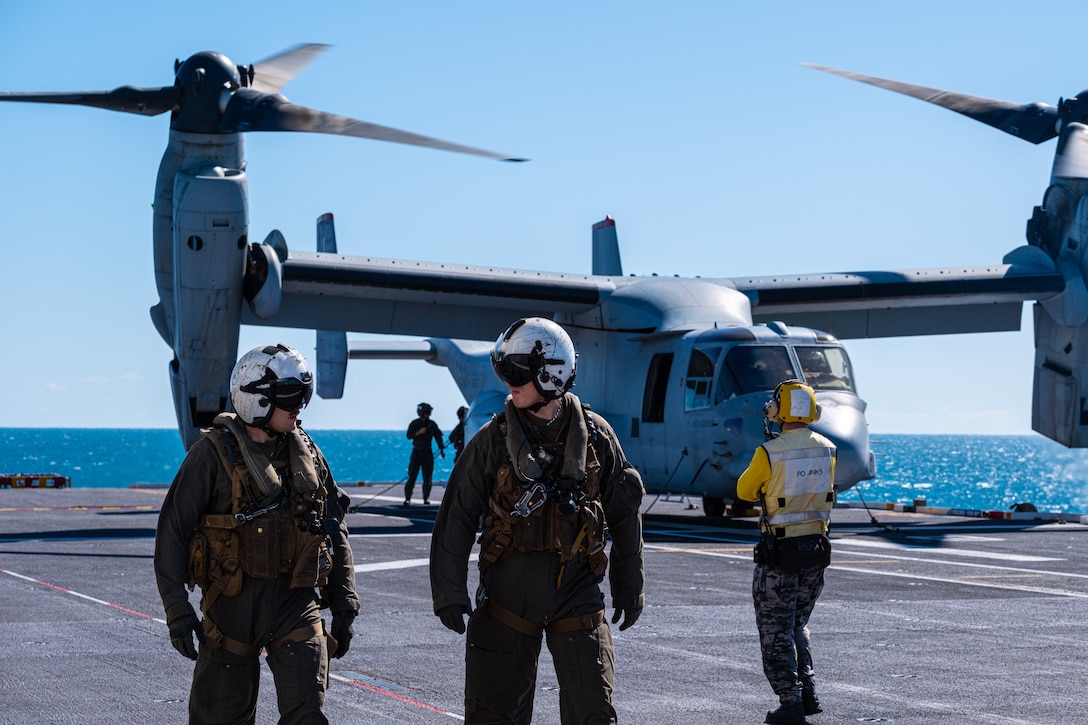 U.S. Marines with Marine Medium Tiltrotor Squadron 363 (Reinforced), Marine Rotational Force - Darwin 23 and Royal Australian Navy Sailors stand on the flight deck of Royal Australian Navy ship HMAS Adelaide (L01) during Exercise Southern Jackaroo 23, off the coast of Queensland, Australia, July 8, 2023. Through the continuous progression of training exercises, MRF-D and the Australian Defence Force gain valuable experience and the expertise necessary for the successful execution of complex missions. (U.S. Marine Corps photo by Cpl. Skyler M. Harris)