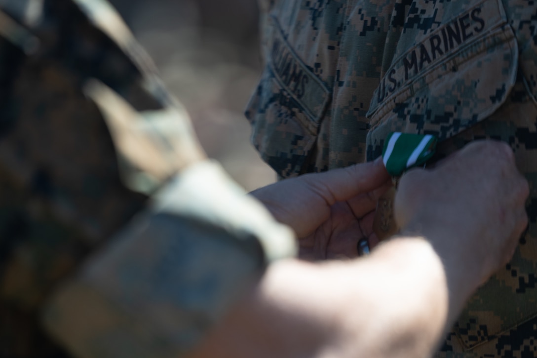 U.S. Marine Corps Cpl. Caleb Williams is pinned with the U.S. Navy and Marine Corps Commendation Medal during a ceremony on Marine Corps Base Hawaii, Dec. 8, 2023. The ceremony was to award Williams, a native of Salisbury, N.C. and an infantry rifleman with 3d Littoral Combat Team, 3d Marine Littoral Regiment, 3d Marine Division, for heroic actions that saved the life of a fellow Marine while on liberty. (U.S. Marine Corps photo by Sgt. Jacqueline C. Parsons)